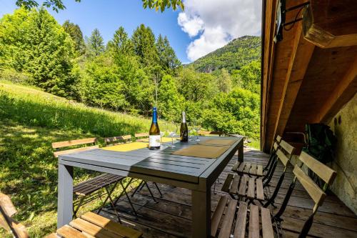 a table with two bottles of wine on a deck at Wunderchalet in Daone