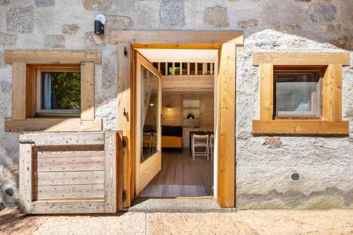 an open door to a building with a table and chairs at Wunderchalet in Daone