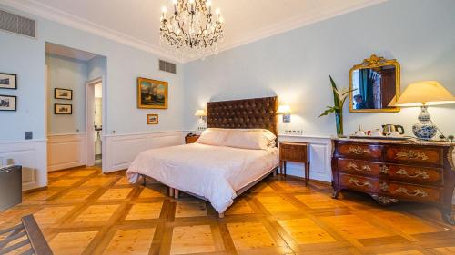 a bedroom with a bed and a dresser and a mirror at Hôtel & Spa Le Bouclier D'or in Strasbourg