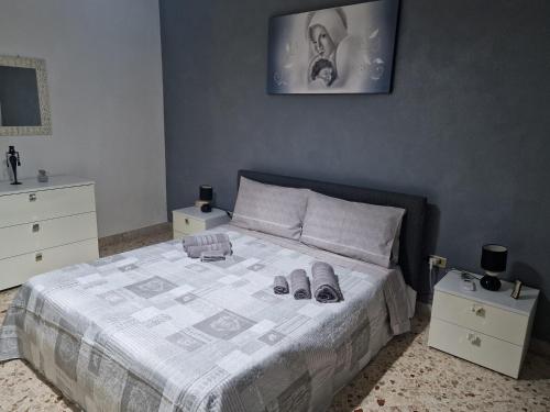 a bedroom with a bed with two pairs of shoes on it at B&B da Giovy in Marsala
