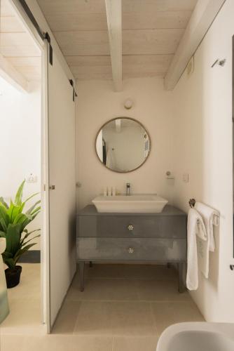 a bathroom with a sink and a mirror at Dimora Talenti City View in Polignano a Mare