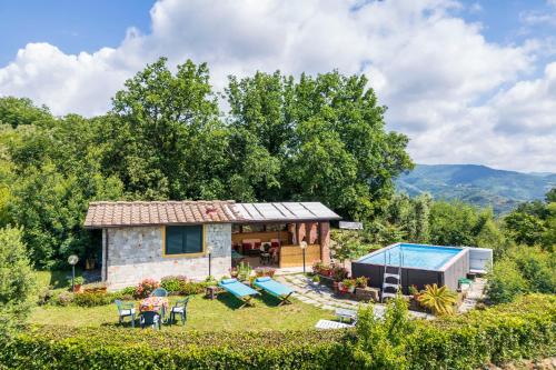 a small house with a pool and a yard at La Casa Di Elda, Holiday Home With Pool, Uzzano, Toscana in Uzzano