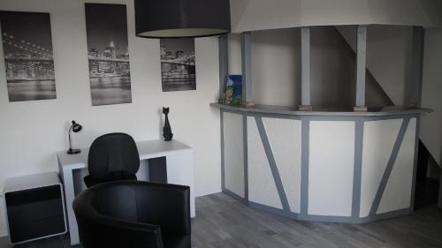 a living room with a desk and a chair at Pension Haus Maria in Mühlhausen