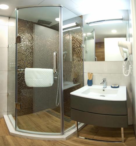 a bathroom with a shower and a sink at Silver 39 Corner Hotel in Tbilisi City