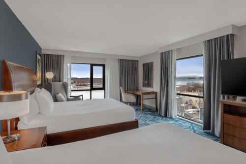 ein Hotelzimmer mit 2 Betten und einem TV in der Unterkunft Hilton Garden Inn Burlington Downtown in Burlington