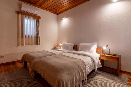 a bedroom with a large bed and a window at Helios House in Selcuk