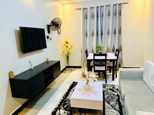 a living room with a couch and a table at Fivas Residences in Arua