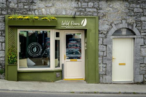 a store with a door and a sign on a building at Idyllic, 5 Star Family Home with Panoramic Views, Kinvara on the Wild Atlantic Way in Kinvara
