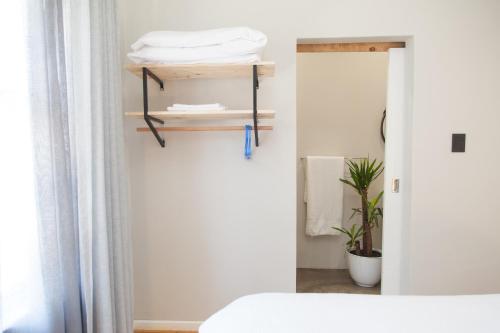 a bedroom with a bed and a mirror at Loddey`s Guest House - by Beach Collection in Strand