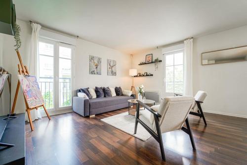 ein Wohnzimmer mit Sofa und Tisch in der Unterkunft Appartement avec Terrasse, Parking et WiFi, DisneyLand Paris in Chessy