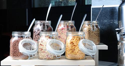a group of jars filled with nuts and seeds at Best Western Airport Hotel Stella in Zagreb