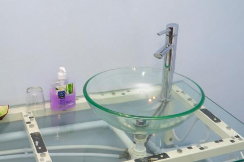 a sink with a faucet on a glass table at The Rusty Pelican in La Gaulette
