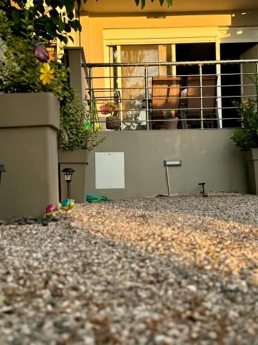 a view of a house with a balcony with flowers at Akrotiri Luxury Suites in Trápeza