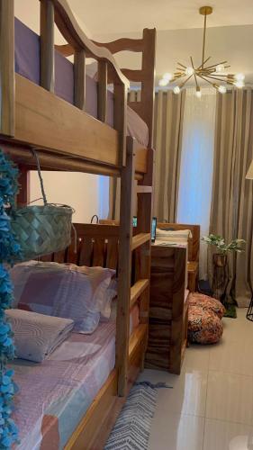 a bedroom with a wooden bunk bed and a desk at SMDC Green 2 Staycation, The Traditional & Modern Fusion Condo in Pasong Bayog