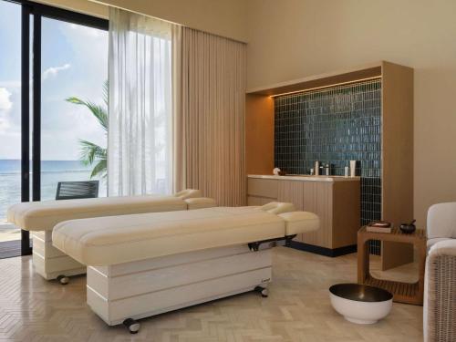 a hospital room with two beds and a large window at SO/ Maldives in South Male Atoll