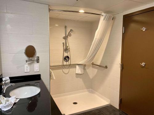a bathroom with a sink and a shower at Radisson Hotel Southfield-Detroit in Southfield