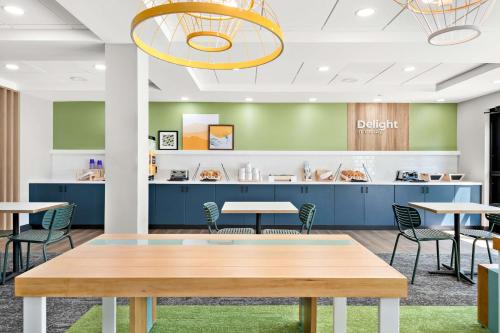 a waiting area at a dental office with tables and chairs at Spark by Hilton Lancaster Dutch Country in Lancaster