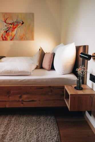 a couch with pillows on it in a room at Rosa Alpina Appartement in Bürserberg
