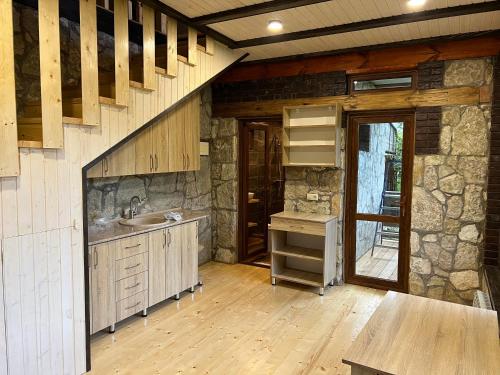 a large kitchen with a sink and a staircase at Balkonchik GuestHouse in Dilijan