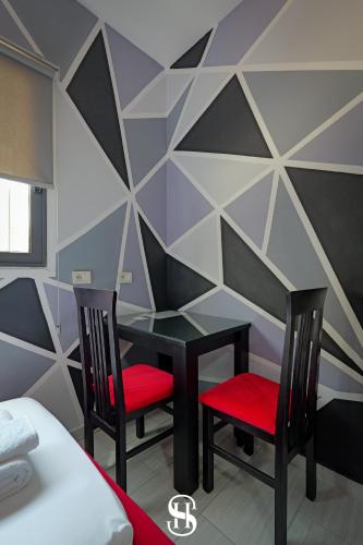 a dining room with a table and two chairs at Hotel SALA in Sarandë