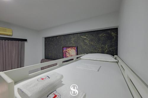a white bed in a room with at Hotel SALA in Sarandë