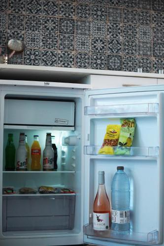 an open refrigerator filled with drinks and drinks at Typic Marina Playa - Adults Only in San Antonio Bay