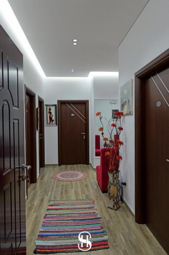 a hallway with a door and a rug at Hotel SALA in Sarandë