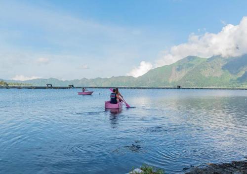 a woman sitting on a raft in a body of water at Yucabin Kintamani in Kubupenlokan