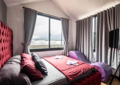 a bedroom with a bed and a large window at Yucabin Kintamani in Kubupenlokan