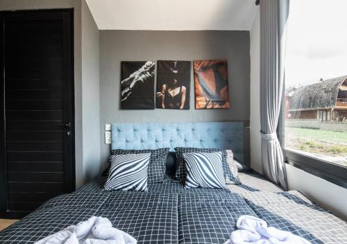 a bedroom with a bed with pillows and a window at Yucabin Kintamani in Kubupenlokan