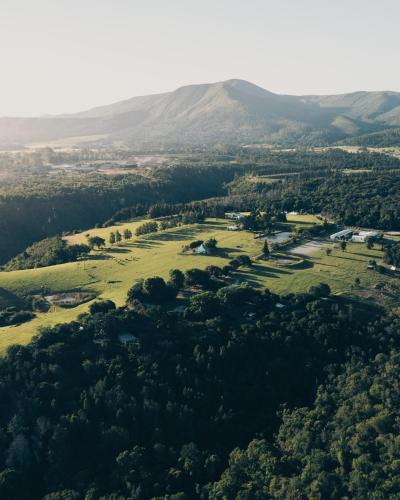 an aerial view of a field with mountains in the background at Firefly Falls in Plettenberg Bay