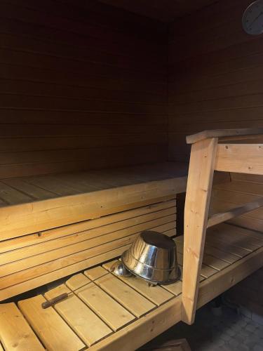 a metal bowl sitting in the inside of a sauna at Lapponia in Kalajoki