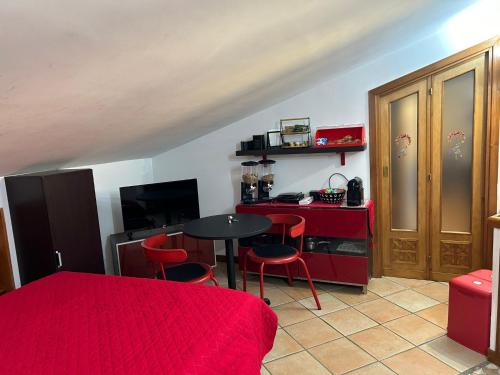 a room with a table and chairs and a kitchen at Frascati Roof 2 in Frascati