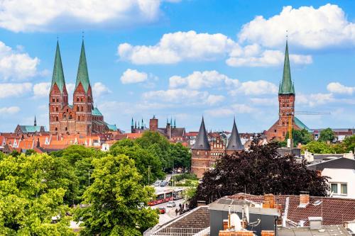 a view of a city with buildings and towers at Mercure Hotel Luebeck City Center in Lübeck