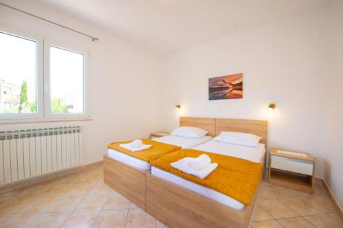 Postel nebo postele na pokoji v ubytování Apartments Cvito