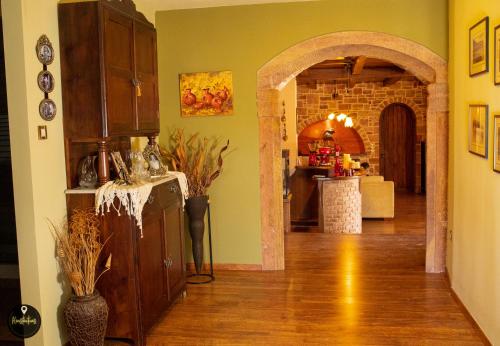 a kitchen with an archway leading into a living room at Luxury House with huge garden - Near "Mavra Volia" Beach in Emporeiós