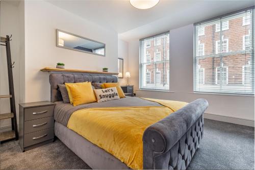 a bedroom with a bed and two windows at WhiskAwayStays - Foregate Street - Apartment 2 in Worcester