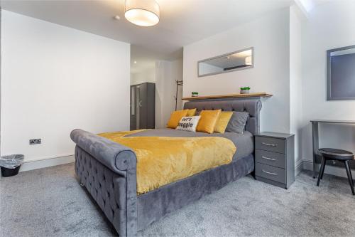 a bedroom with a king sized bed and a television at WhiskAwayStays - Foregate Street - Apartment 2 in Worcester