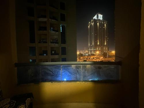 a view of a building at night from a window at The Welcoming Wing in Ajman 