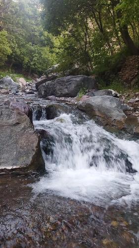 a stream of water in a river with rocks at Gite akswal amssakrou in Ikis