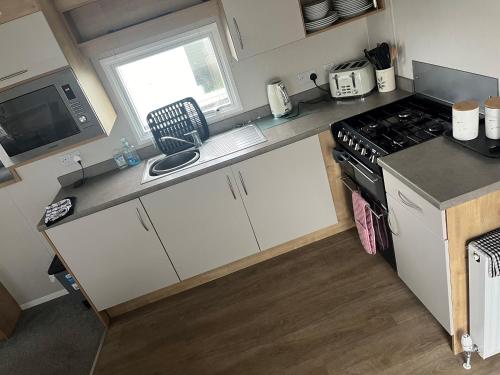 a kitchen with a stove and a counter top at Arthurs Pad WB in Whitley Bay