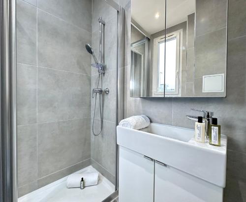 a bathroom with a shower and a white sink at 1562 - Cosy Montmartre in Paris Olympic Games 2024 in Paris