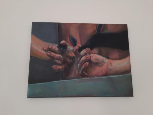 a painting of two hands holding a bird at Apartament GALERIA in Nysa