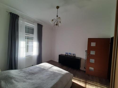 a bedroom with a bed and a window at Apartament GALERIA in Nysa