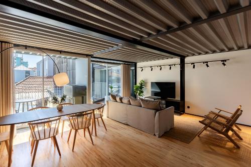 a living room with a table and a couch at Feel Porto Matosinhos City Flats in Matosinhos