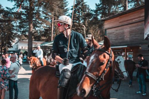 a man is riding a horse on a street at Air Muc Park Sleep & Fly in Hallbergmoos