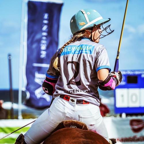 a woman holding a baseball bat next to a horse at Runas Air Muc Park Sleep & Fly in Hallbergmoos
