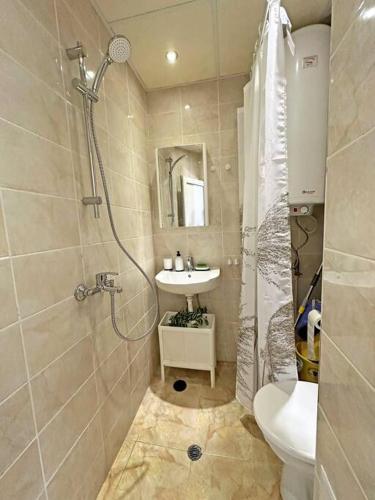 a bathroom with a shower and a sink and a toilet at Beachside Bliss by Mery -Balchik in Balchik