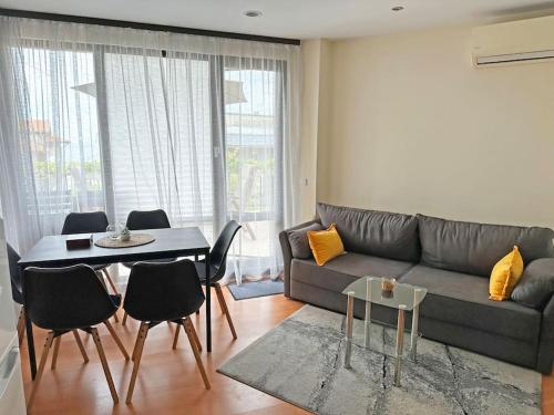 a living room with a couch and a table at Beachside Bliss by Mery -Balchik in Balchik