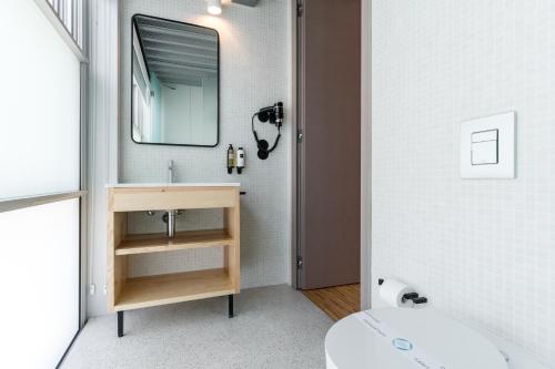 a bathroom with a sink and a mirror at Feel Porto Matosinhos City Flats in Matosinhos